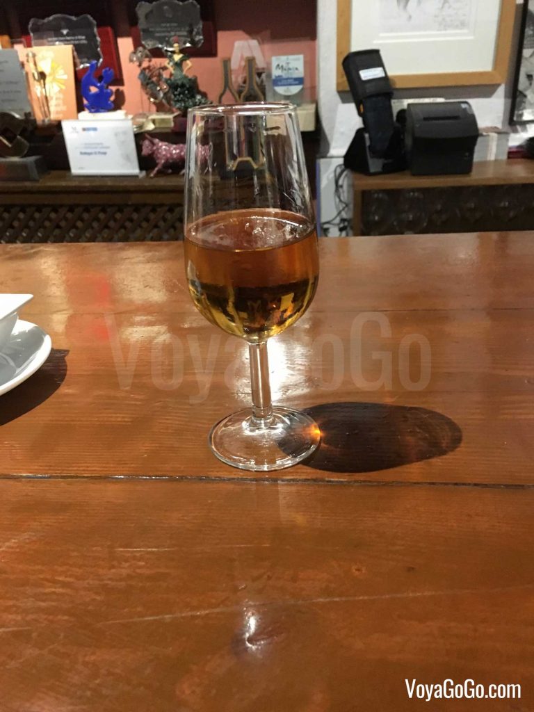 View of a glass of Pajaretes, at the bar of El Pimpi in central Malaga.   Voyagogo.com Travel Blogs.